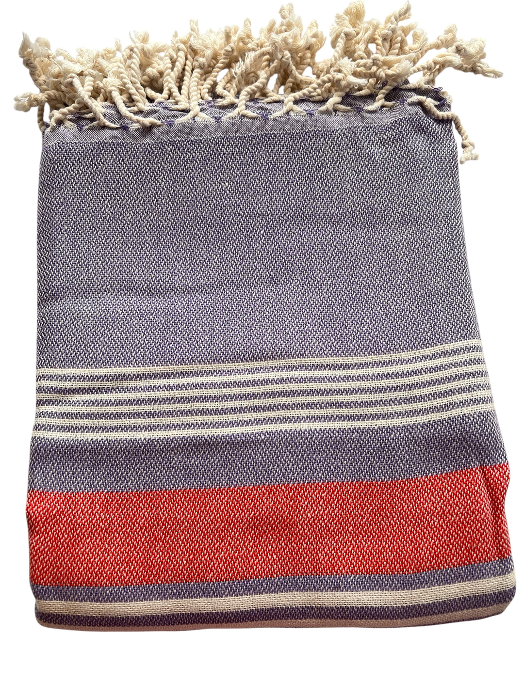 The New York Pink Organic Cotton Beach Towel from turkanhome.com features a textured pattern and cream fringe, with blue, red, and white stripes—perfect as an extra-long beach towel for relaxing days by the water.