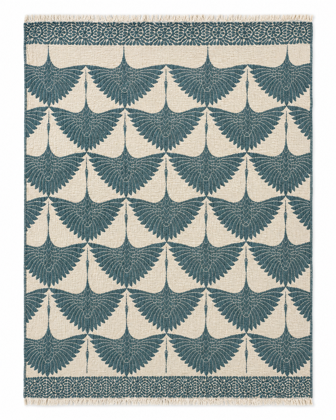 The Crane Muslin Throw Blanket Natural Border– Reversible Turkish Cotton from turkanhome.com features a rectangular design with a repeating pattern of teal birds in flight on a cream background, framed by a row of circular floral motifs and finished with fringe on the shorter edges—this elegant piece combines the beauty of Turkish cotton with reversible versatility, offering both style and comfort to your home.