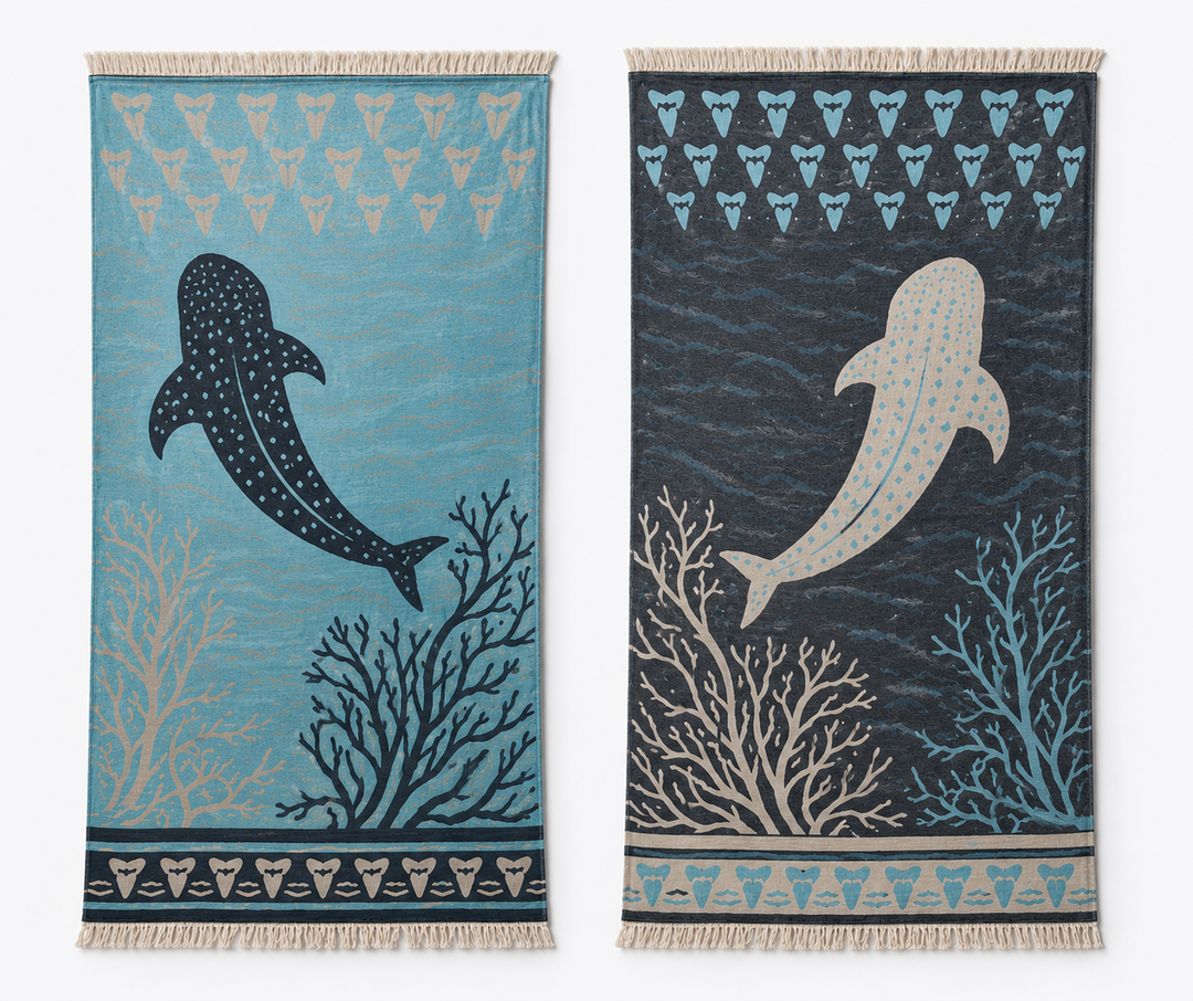 Drawing inspiration from the turkanhome.com Whale Shark Towel – Reversible Turkish Beach Towel, these two woven rugs showcase whale sharks, coral motifs, and rows of shark teeth along the top and bottom edges. One features a light blue background while the other displays a dark blue backdrop, with each design rendered in contrasting hues. Both rugs are finished with fringed edges for added texture and charm.