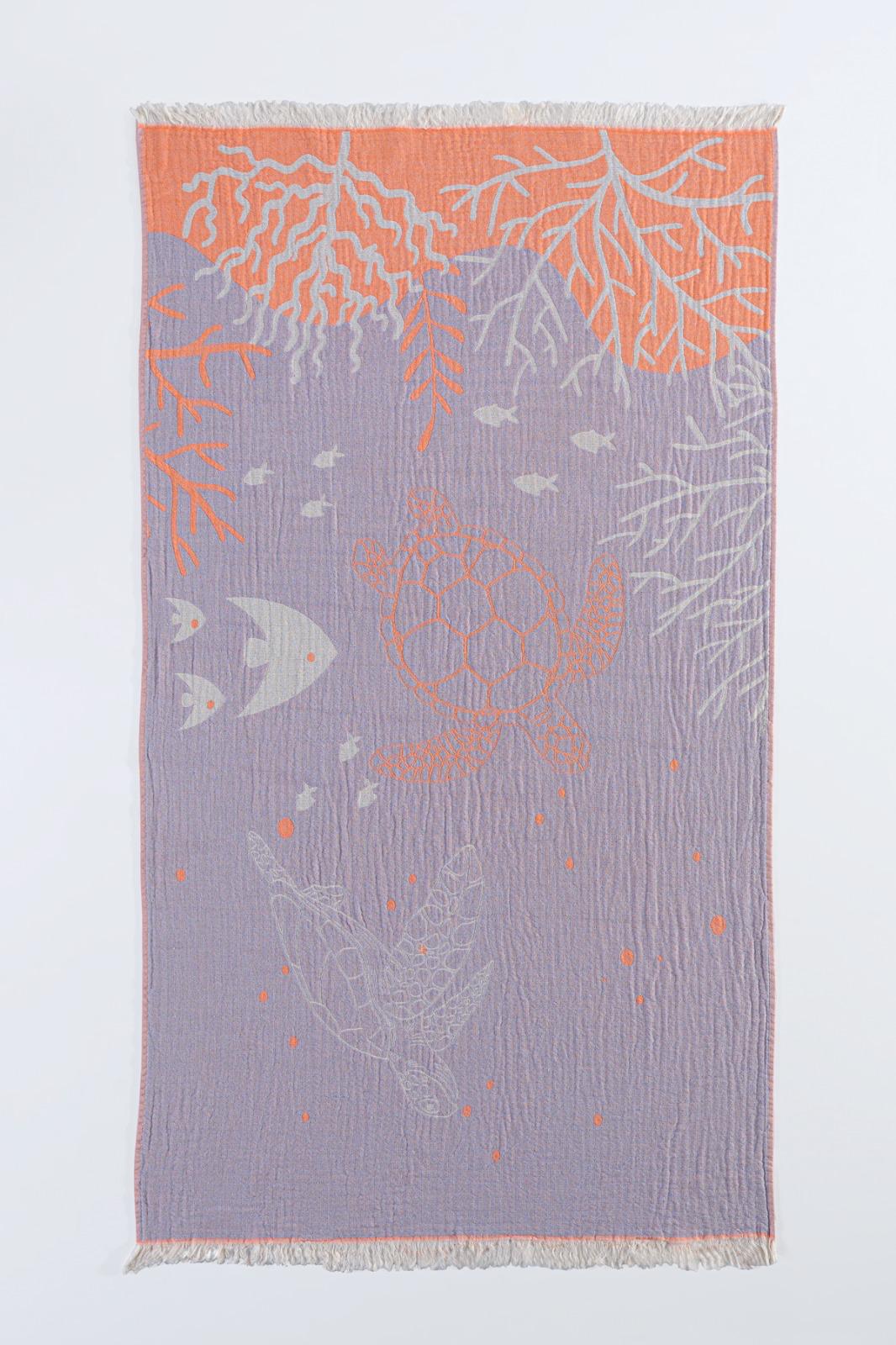 The Reef and Turtle Towel from turkanhome.com is a 100% cotton woven textile with fringed edges, featuring an underwater scene in orange, white, and lavender on a pale lavender background—perfect as a quick-drying Turkish towel.