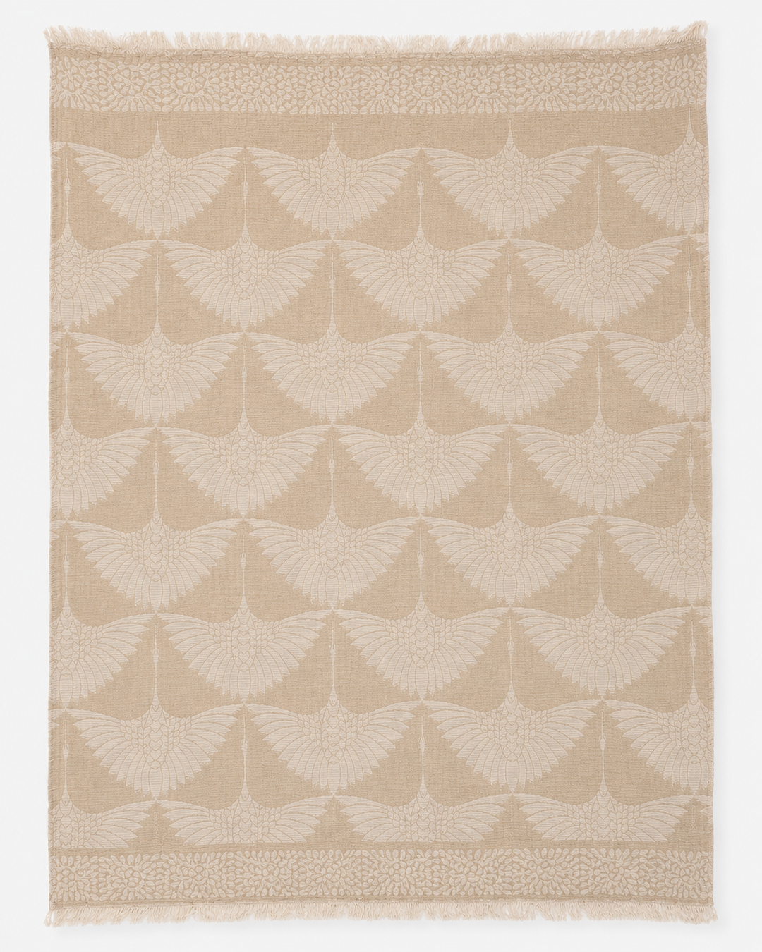 The Crane Muslin Throw Blanket in Natural Border from turkanhome.com features a beige Turkish cotton textile adorned with a repeating motif of stylized cranes in flight, wings outstretched, and is finished with decorative borders at the top and bottom edges. Expertly crafted as a reversible throw, it includes fringe along the shorter sides.