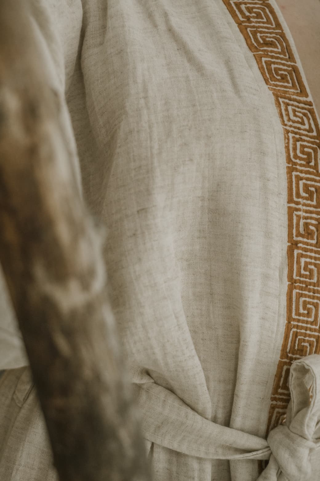 The Triable Boho Kimono Robe by turkanhome.com is a beige linen poolside beach cover up, featuring a brown geometric Greek key trim and a waist tie.