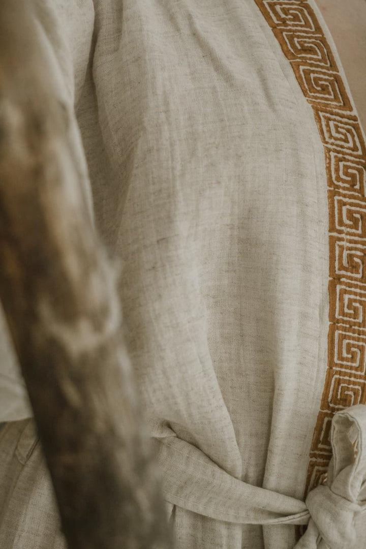 The Triable Boho Kimono Robe by turkanhome.com is a beige linen poolside beach cover up, featuring a brown geometric Greek key trim and a waist tie.