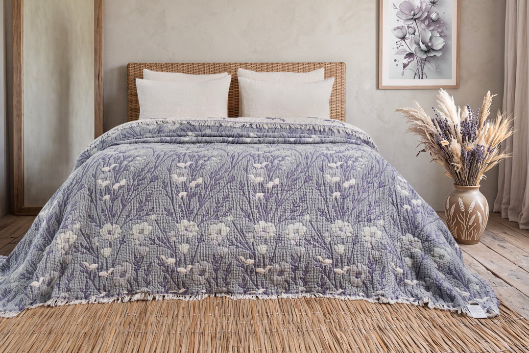 Purple floral king quilt arranged across a bed