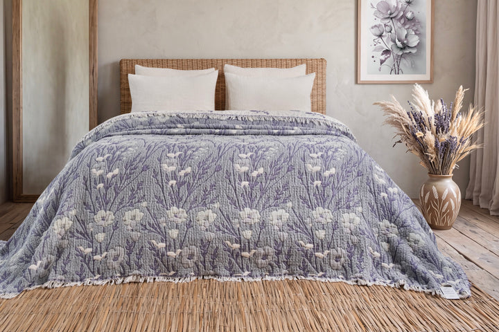 Purple floral king quilt arranged across a bed