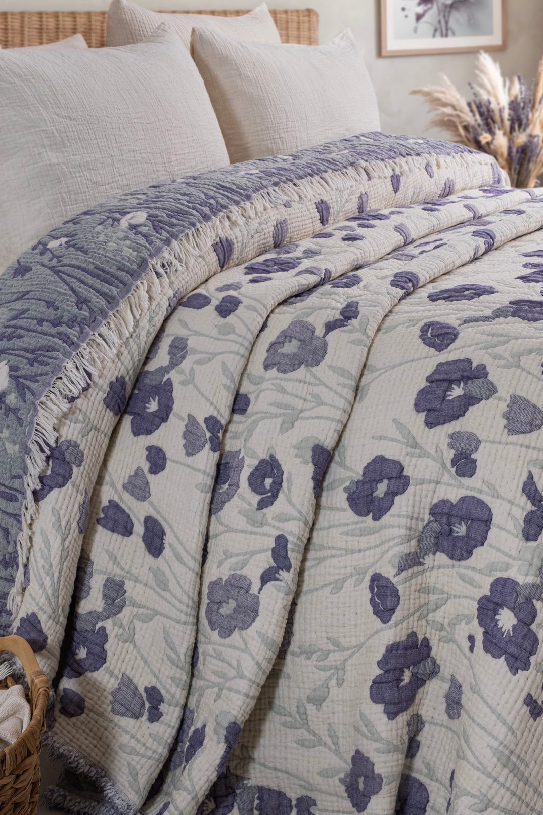 Close view of the folded purple floral muslin quilt