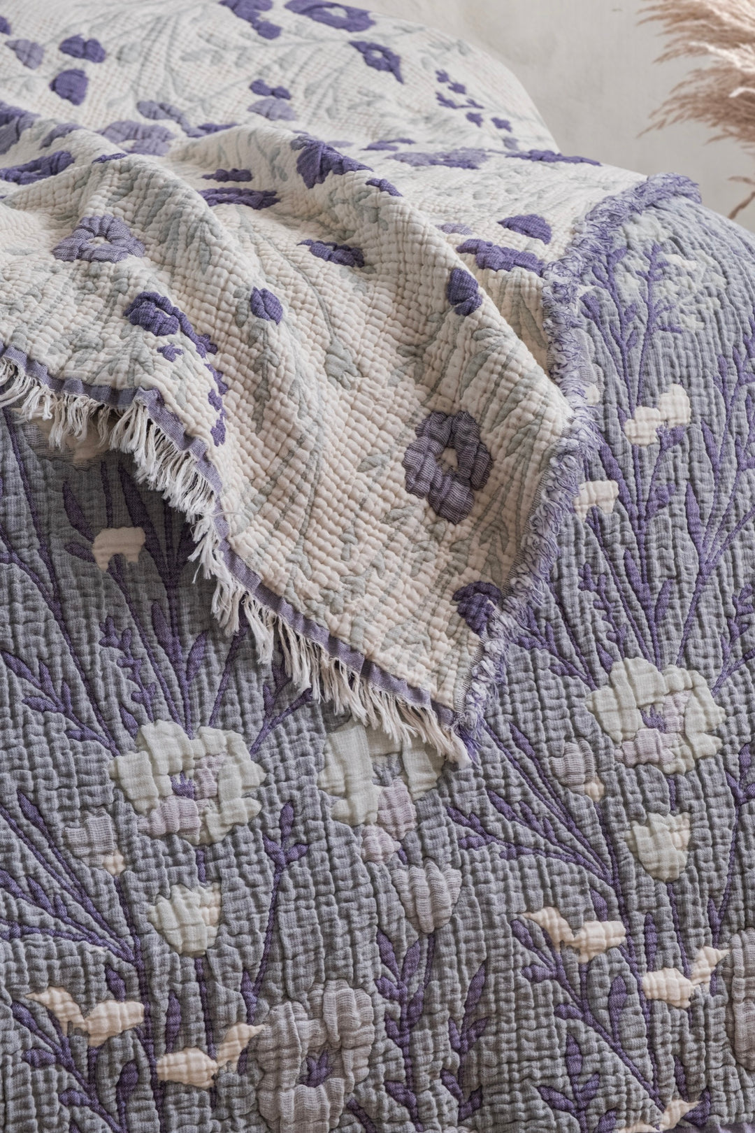 Close-up of the quilted texture and purple floral print