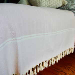 hand loomed bed blanket on bed